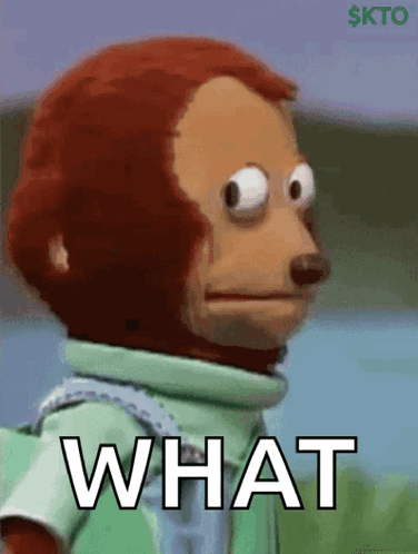 A Stuffed Monkey With A Green Shirt And The Word What On It GIF