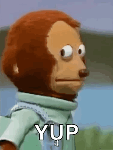 A Stuffed Monkey With Big Eyes Is Standing In Front Of A Sign That Says Yup . GIF