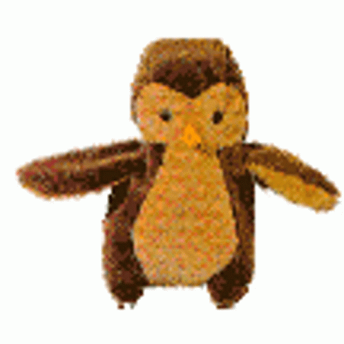 A Stuffed Owl With Wings Is Sitting On A White Surface . GIF