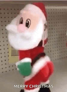 A Stuffed Santa Claus Is Standing In A Store Holding A Cup Of Coffee And Says Merry Christmas . GIF