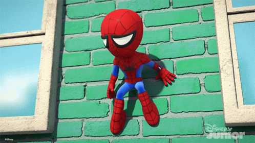 A Stuffed Spider Man Is Hanging On A Green Brick Wall From Disney Junior GIF