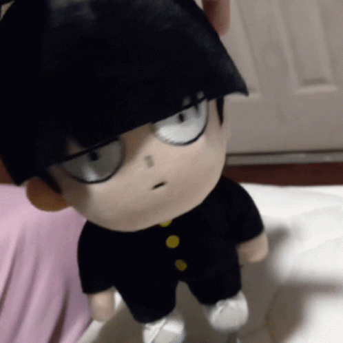 A Stuffed Toy Of A Boy With Black Hair And Glasses GIF