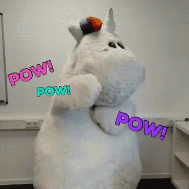 A Stuffed Unicorn Says Pow In Purple And Blue Letters GIF