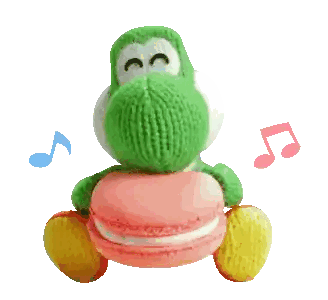 a stuffed yoshi with a pink macaron in its mouth