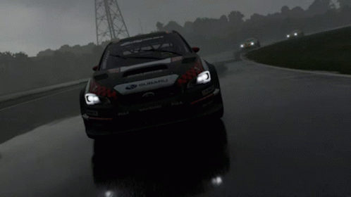 A Subaru Is Driving Down A Wet Road In The Rain GIF