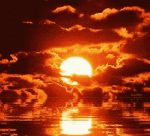 A Sunset Over A Body Of Water With A Lot Of Clouds GIF