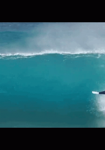 A Surfer Is Riding A Wave In The Ocean GIF