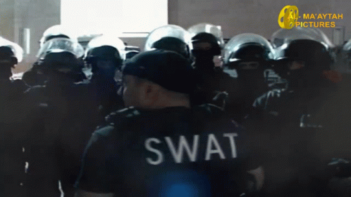 A Swat Officer Stands In Front Of A Crowd Of Police GIF