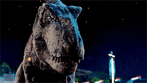 A T-Rex Dinosaur Is Standing In The Dark With Its Mouth Open . GIF