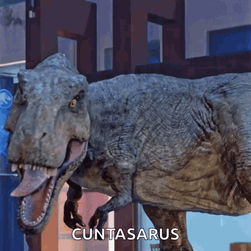 A T-Rex With Its Tongue Hanging Out And The Word Cuntasarus Written Below It GIF
