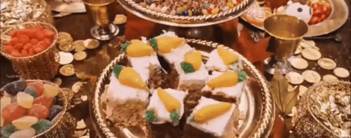 A Table Topped With Plates Of Food And A Bowl Of Fruit . GIF