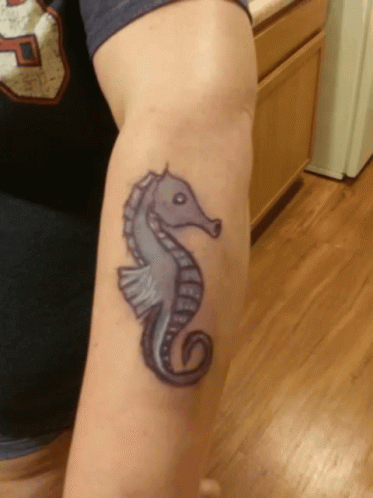 A Tattoo Of A Seahorse On A Person 'S Arm GIF