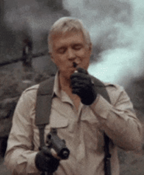 A Team Lighting Cigar With Explosion At The Back GIF
