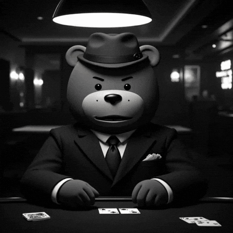 a teddy bear in a suit and fedora holding a bunch of cards