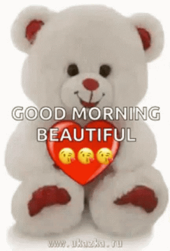 A Teddy Bear Is Holding A Red Heart With Smiley Faces On It And Saying `` Good Morning Beautiful '' . GIF