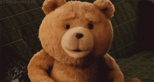 A Teddy Bear Is Sitting On A Couch With Edgar Alanfrog Written In The Corner GIF