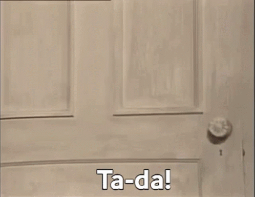 A Teddy Bear Is Standing In Front Of A Window And Says Ta-Da ! GIF