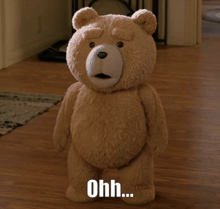 A Teddy Bear Is Standing On A Wooden Floor With The Words Ohh Written Below It GIF