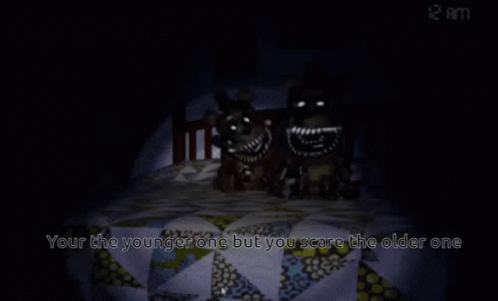 A Teddy Bear Sits In A Bed With The Words " Your The Younger One But You Scare The Older One " GIF