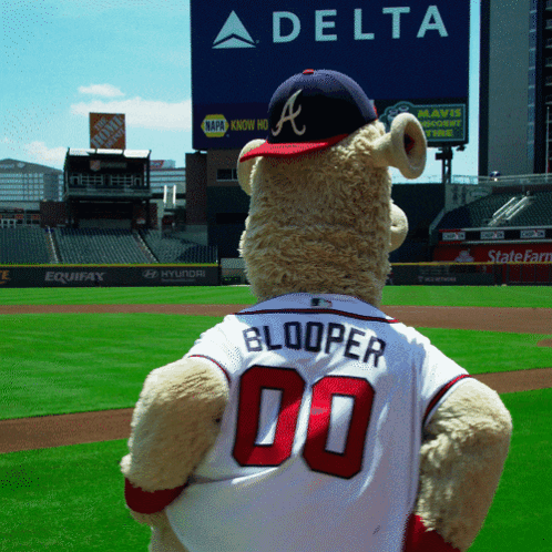 A Teddy Bear Wearing A Jersey That Says Booper 00 Stands On A Baseball Field GIF