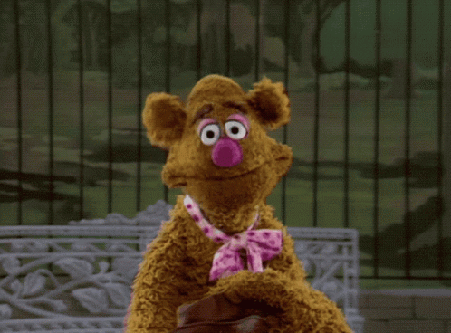 A Teddy Bear With A Pink Nose And Tie GIF