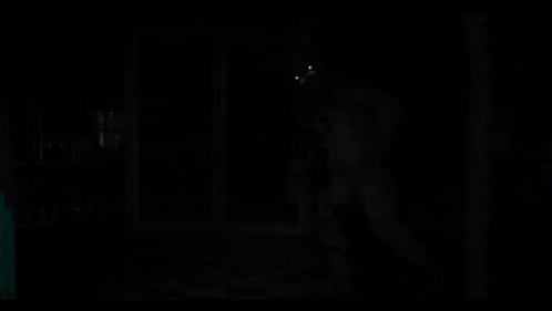 A Teddy Bear With Glowing Eyes Is In The Dark GIF