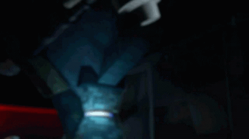 A Teenage Mutant Ninja Turtle With A Blue Headband Is Laying Down GIF