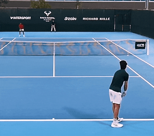 a tennis court with advertisements for richard mille and intersport in the background