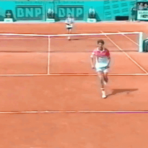 A Tennis Match Is Being Played In Front Of A Bnp Sign GIF