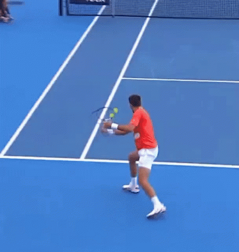 A Tennis Player In A Yellow Shirt Is About To Hit A Ball GIF