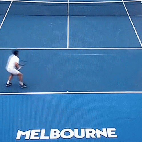 A Tennis Player Is Falling On A Court With The Word Melbourne On It GIF
