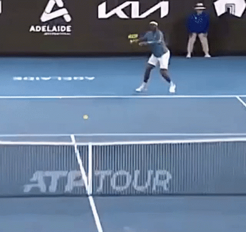 a tennis player is hitting a tennis ball on a blue court