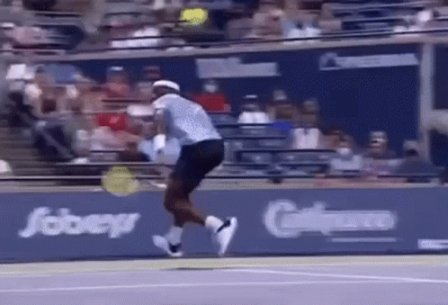 a tennis player is jumping in the air while holding a tennis racquet .