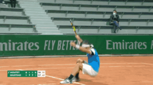 A Tennis Player Is Kneeling Down On The Court In Front Of An Emirates Advertisement GIF