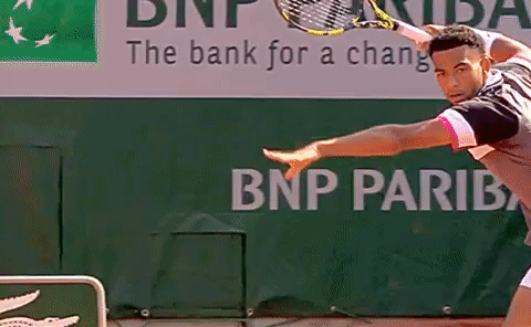 A Tennis Player Is Playing In Front Of A Bnp Pariba Sign GIF