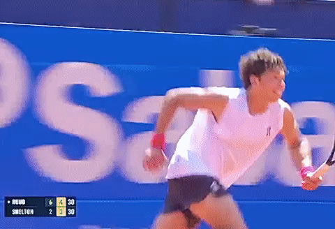 A Tennis Player Is Running In Front Of A Sign That Says Swelton GIF