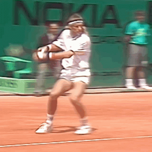 A Tennis Player Is Swinging A Tennis Racket On A Court With Nokia Written On The Wall Behind Him GIF