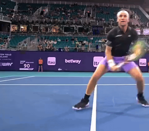 A Tennis Player On A Court With A Banner That Says ' Itau ' On It GIF