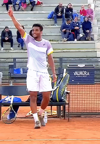 a tennis player on a court with a sign that says valanora