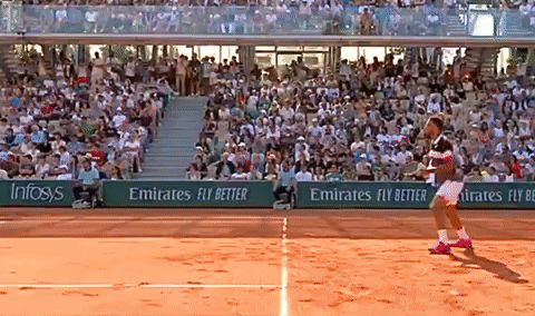 A Tennis Player On A Court With Emirates Fly Better Advertisements On The Sidelines GIF
