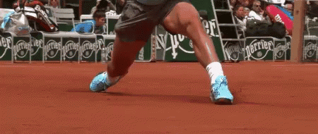 A Tennis Player 'S Legs Are Shown In Front Of A Perrier Advertisement GIF