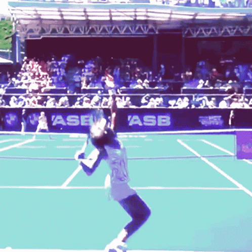 A Tennis Player Serves The Ball In Front Of A Banner That Says Asb On It GIF