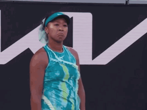 A Tennis Player Stands In Front Of A Sign That Says Ky GIF
