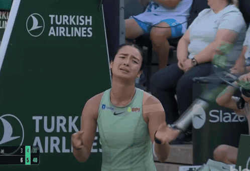 A Tennis Player Stands In Front Of A Turkish Airlines Sign GIF