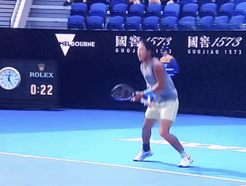 A Tennis Player Stands On A Court With A Rolex Sign In The Background GIF