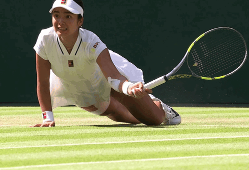 A Tennis Player Wearing A Bn Shirt Is Holding A Racket GIF
