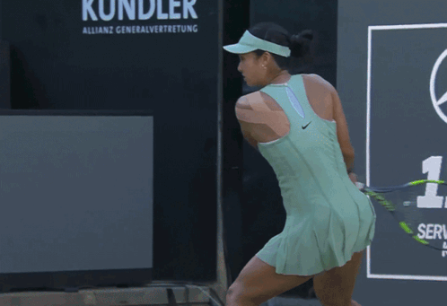 A Tennis Player Wearing A Green Tank Top With Bpi Written On It GIF