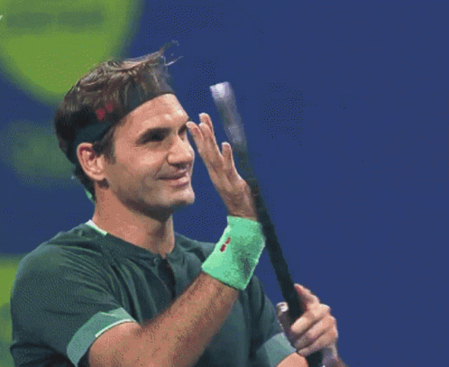A Tennis Player Wearing A Headband Holds A Tennis Racquet GIF
