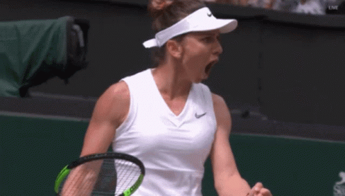 a tennis player wearing a nike visor is holding a tennis racquet