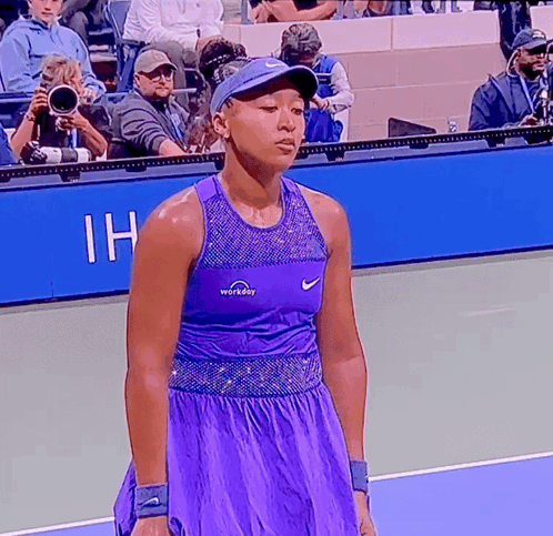 A Tennis Player Wearing A Purple Workday Top GIF